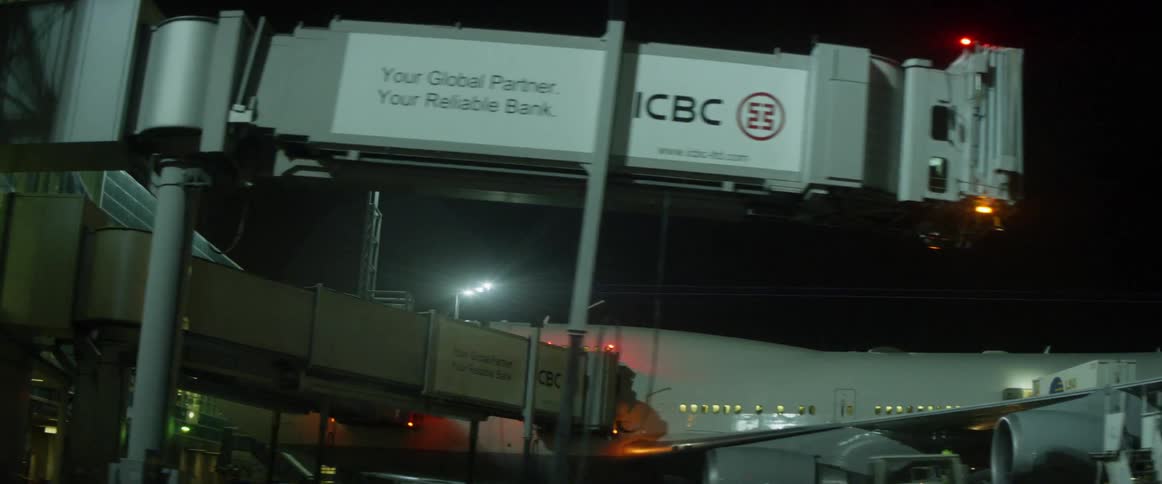 An airplane is preparing for boarding at an airport at night
