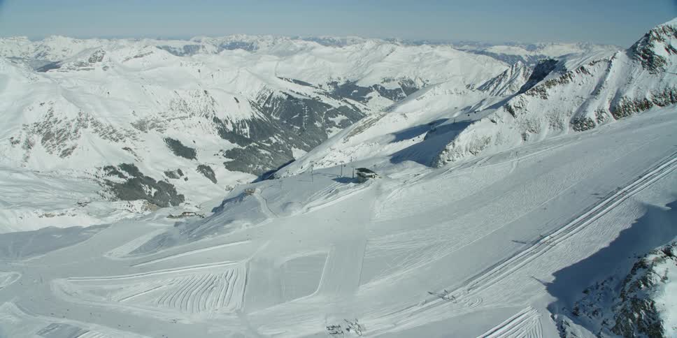 Sun shines down over snow covered mountains