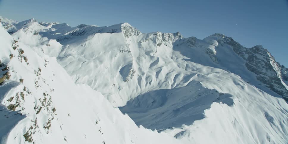 Flying by the smaller Hohe Warte mountain peak with the Olperer mountain in the background