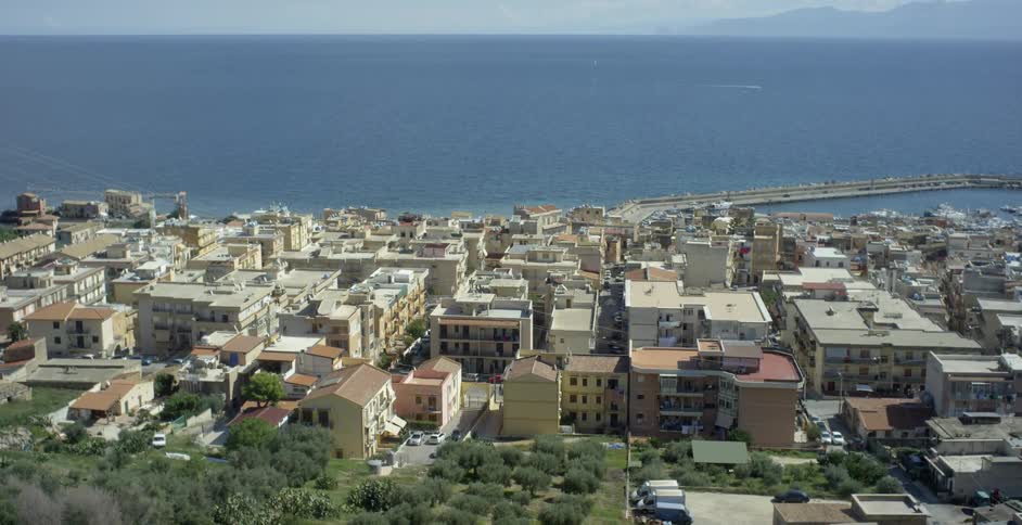 A man overlooks coastal buildings