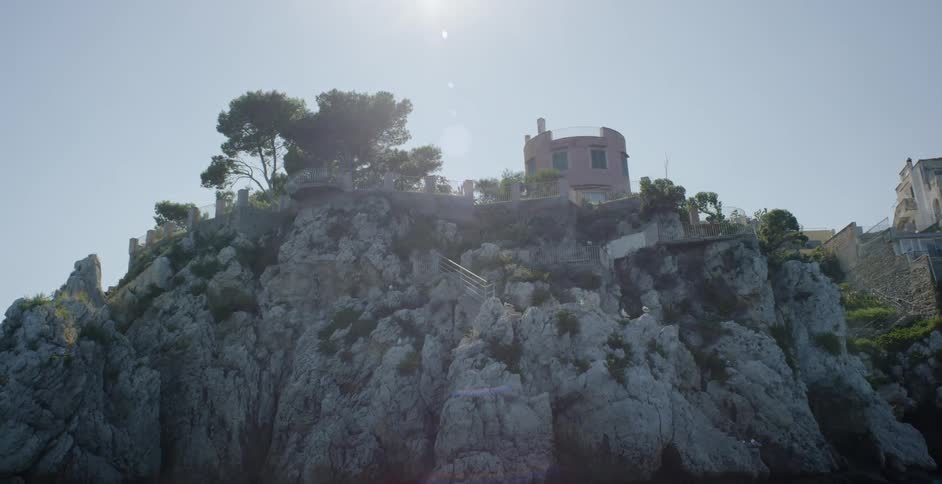 A building sits on top of a rocky cliff