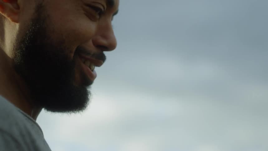 Man is talking and laughing outside on cloudy day