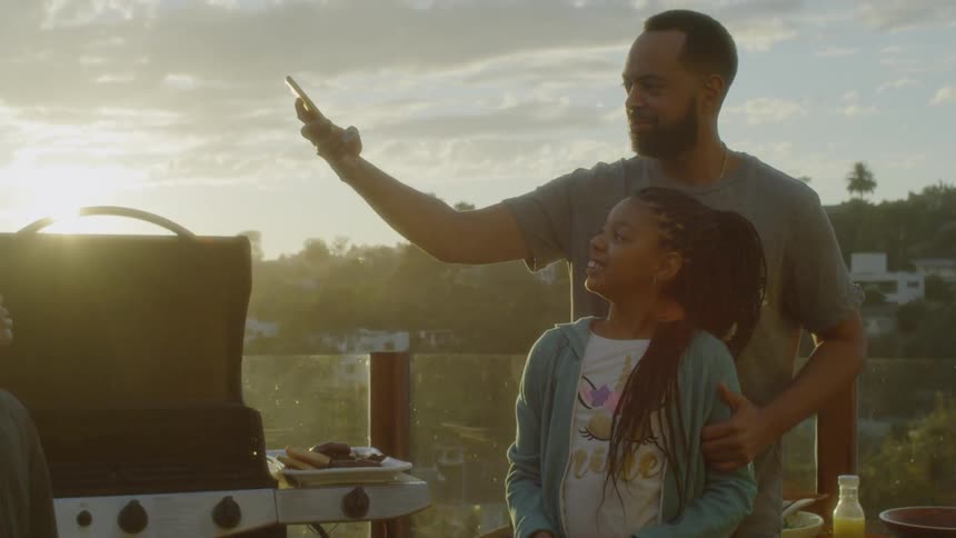 Man takes selfie outside with daughter