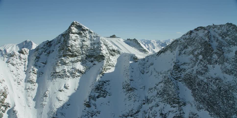 Sun shines down on snowy mountains