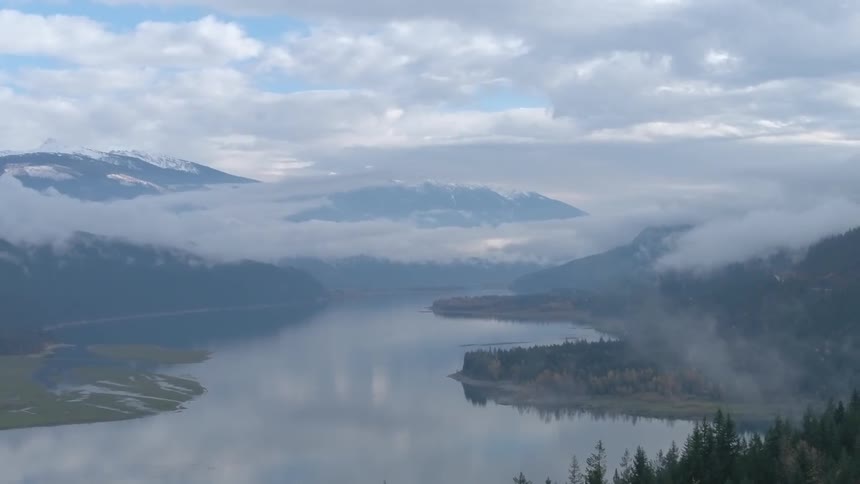 Clouds float above a mountain lake