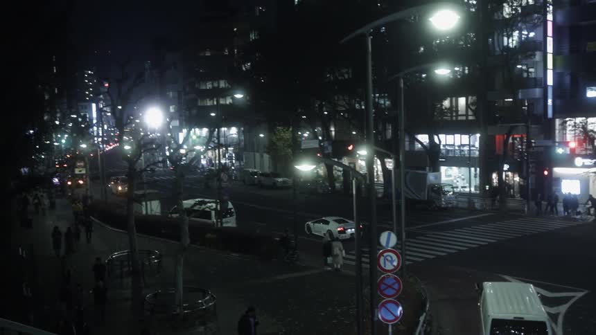 A sports vehicle makes a turn in the intersection at night
