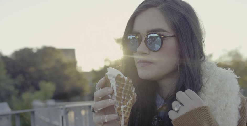A woman is eating an ice cream cone