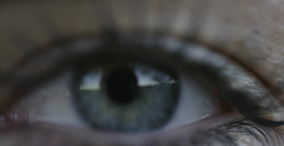 A woman's eye blinks and looks forwards
