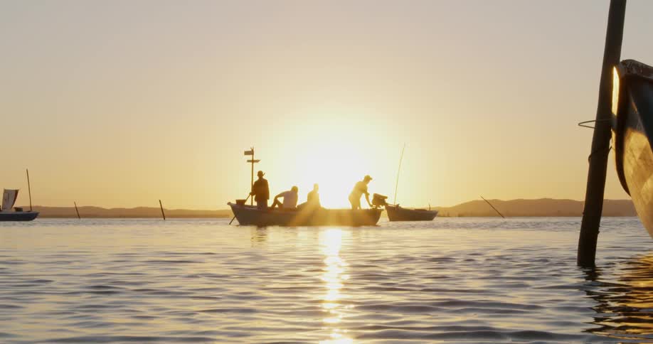 A group of people are traveling in a small boat