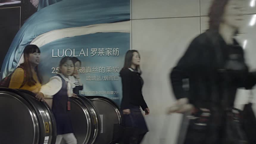 The people travel up the escalator and walk forward
