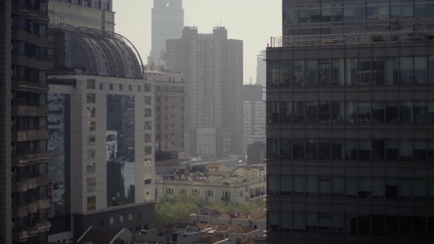 Tall buildings in city on smoggy day