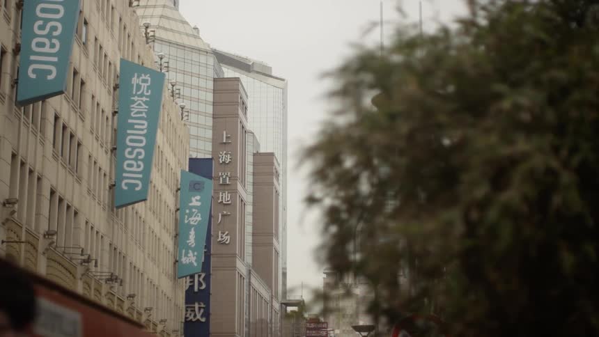 There are signs lining the side of the building