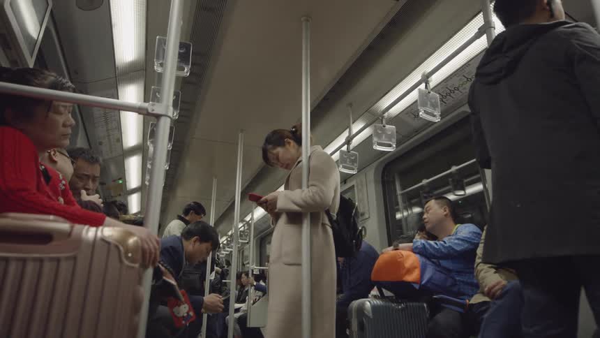 Commuters ride on a subway train