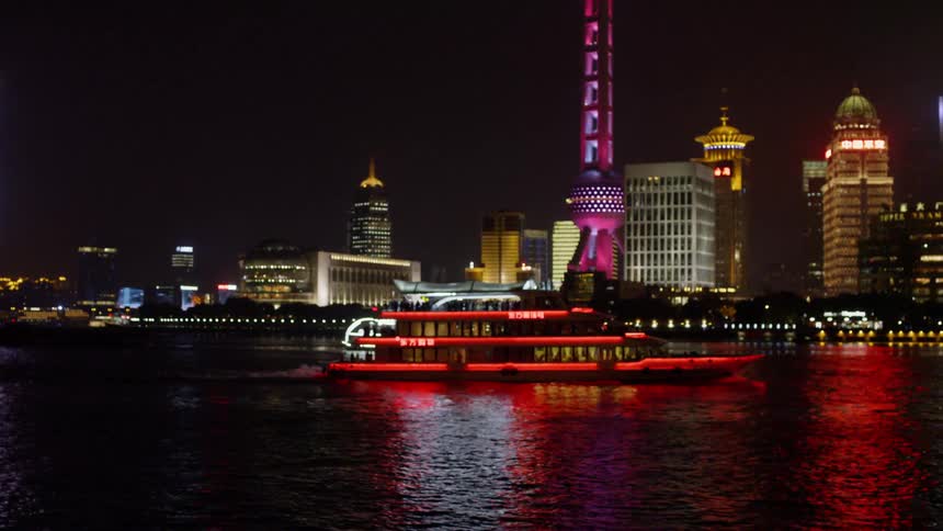 A boat floats in a city bay