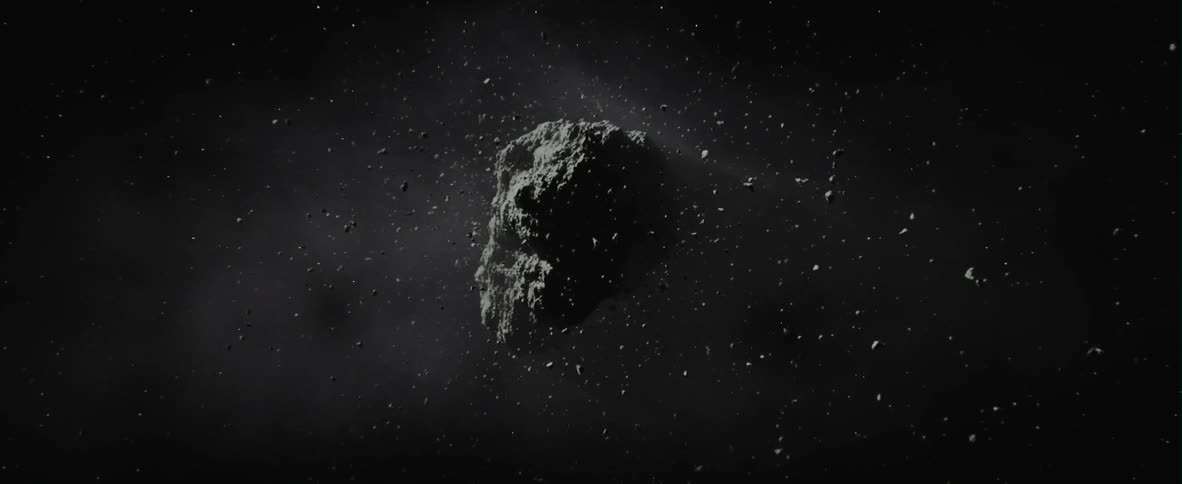 Large rock in a dark area with debris floating around