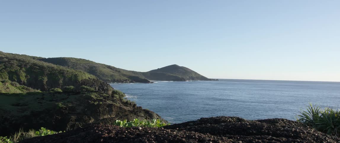 View of an ocean with a rocky coast