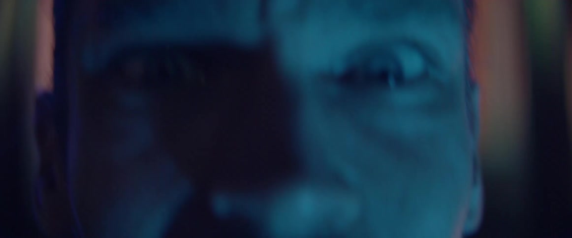 A frustrated male face looks into the camera with an intense angry expression.