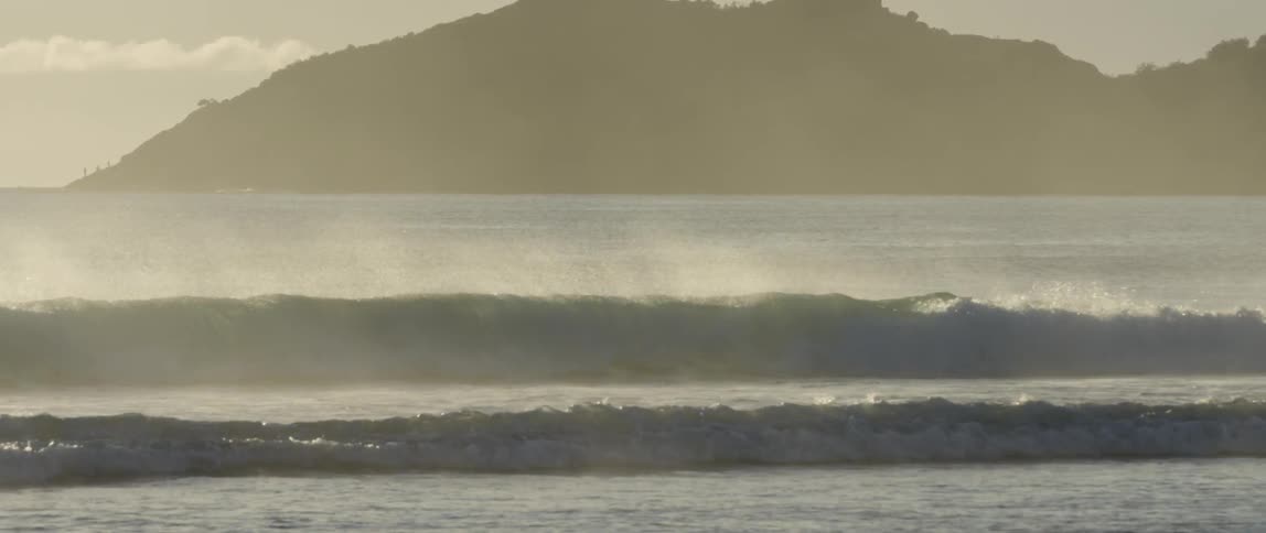 Waves hitting the shore on a foggy day