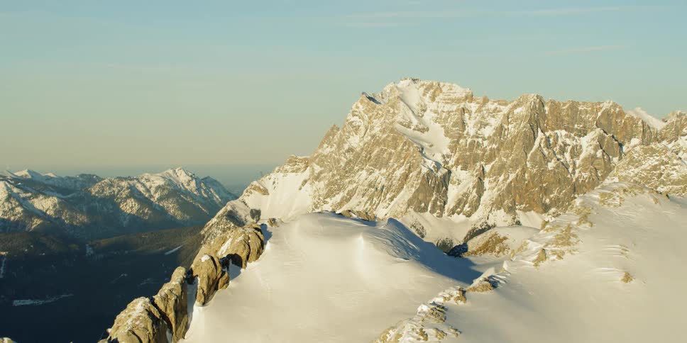 Heavy snow covers the mountains on a cloudy day