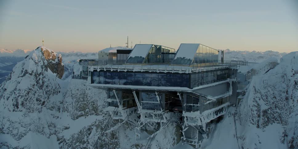 The large building is hanging off the side of a cliff