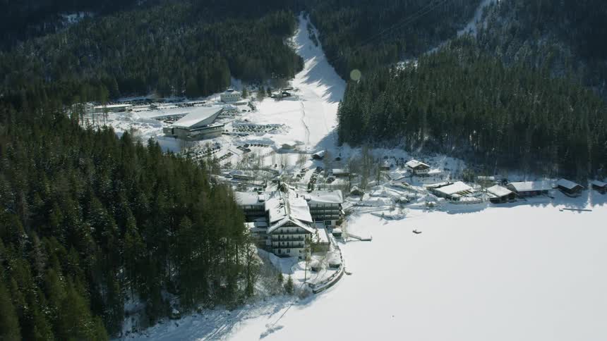 Mountain town covered in snow and surrounded by trees