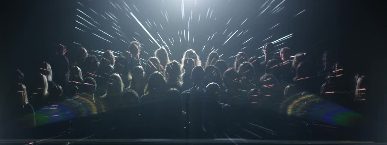 Lights shine on a performing choir