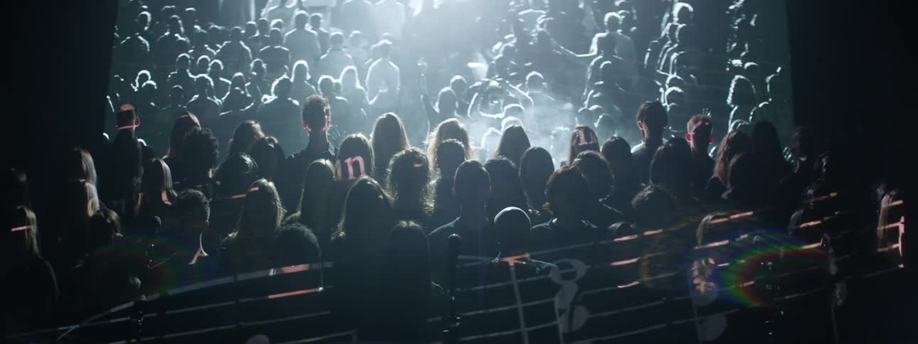 A choir is singing as images are projected behind them