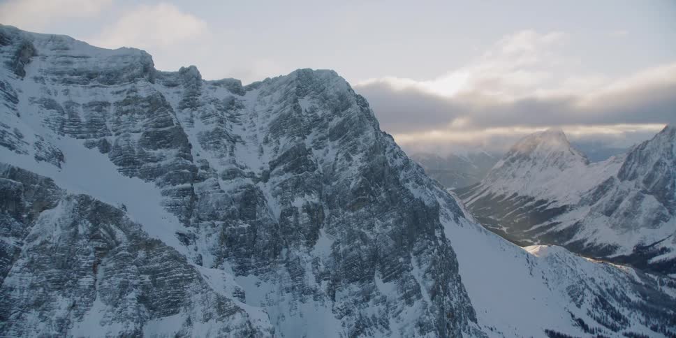 Snow-covered mountains at a somewhat cloudy sunset