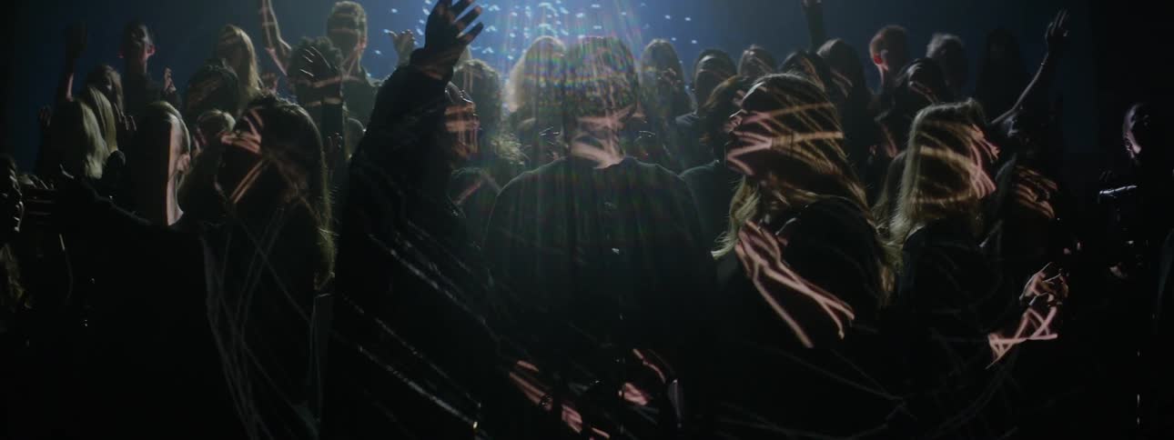 Lights are being projected onto a choir as it is singing