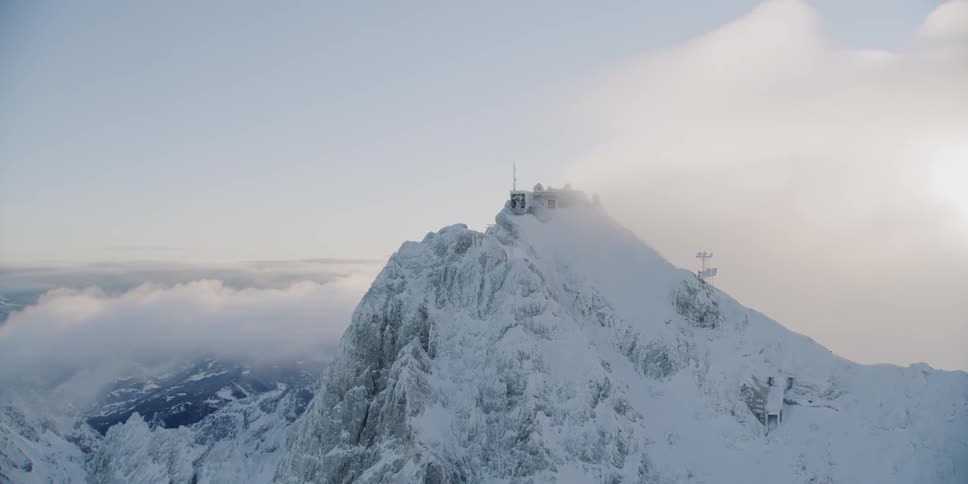 Snow-covered mountains at a somewhat cloudy sunset