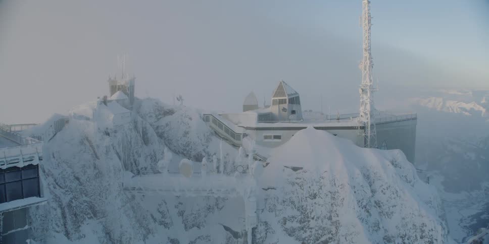 A building sits on a snowy mountain peak