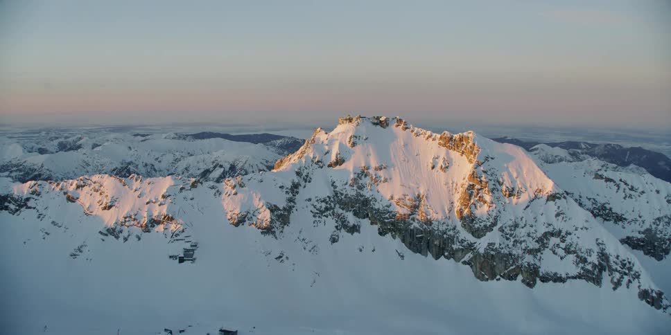 The sun shines on a snowy mountain