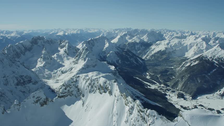 Snow covered mountain peaks on sunny day