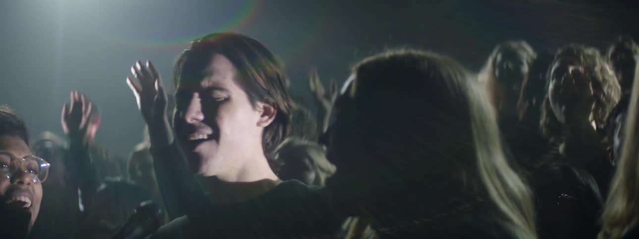 A choir sings in the dark