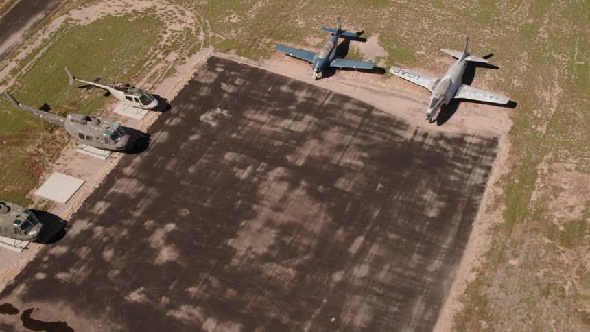 The runway is clear with aircrafts parked along the pavement