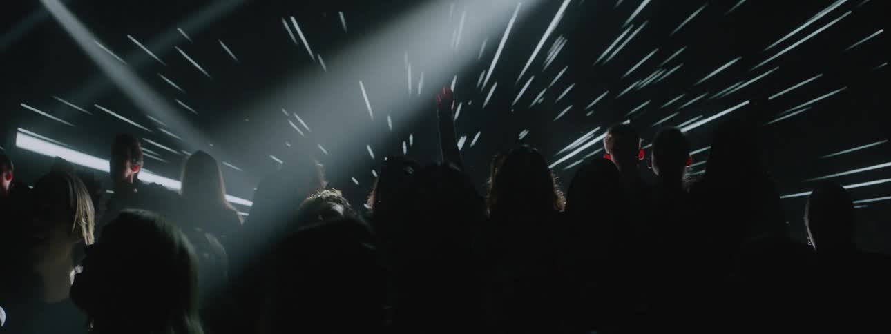 Lights shine and flash around a group of people