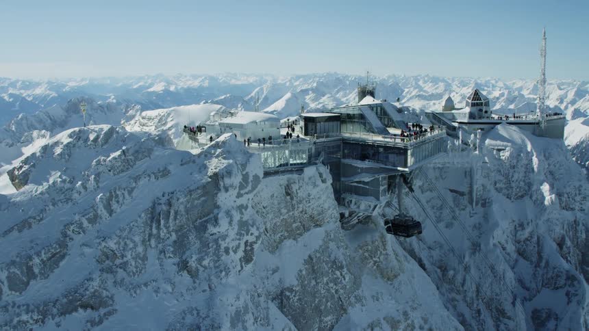 Resort building on top of snow covered mountain peak