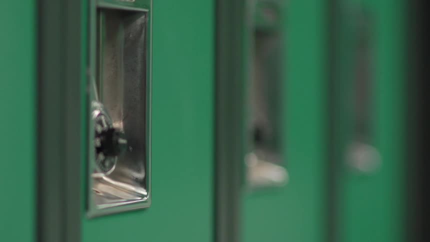 The green locker is locked with a padlock
