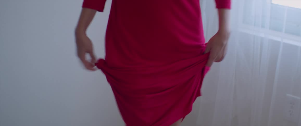 A woman is dancing inside of her home