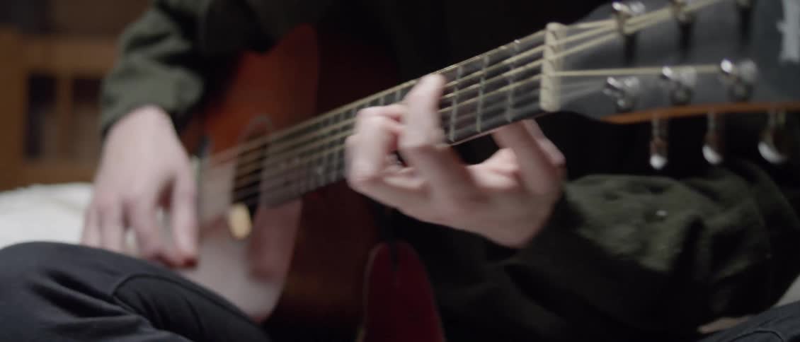 A man plays an acoustic guitar