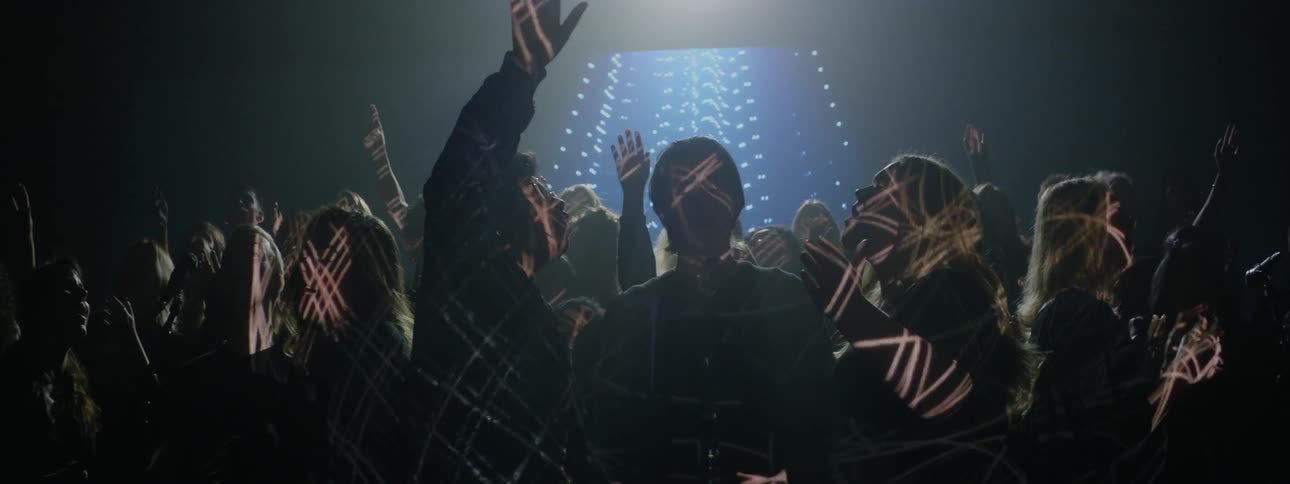 A projection plays behind a singing choir