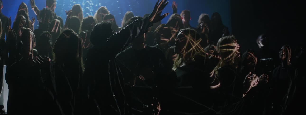 A projection is displayed on a singing choir