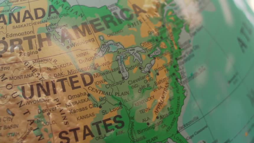 A globe spins and stops on north america