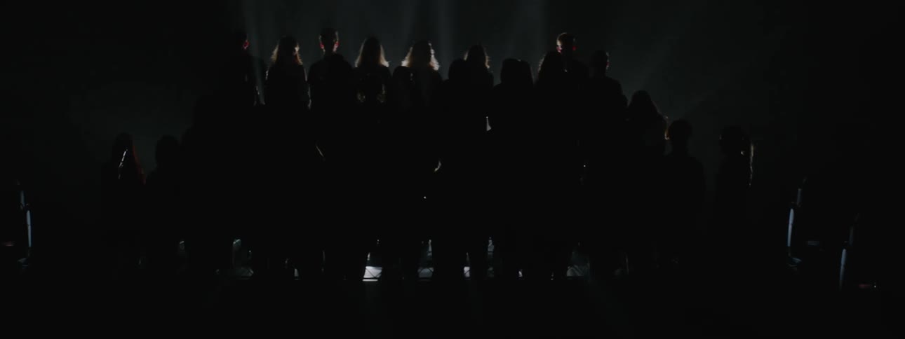 Group of people standing backlit