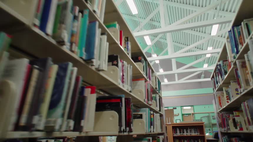 Books on shelves in a well lit library
