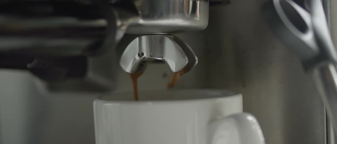 Liquid pours out of a metal spigot