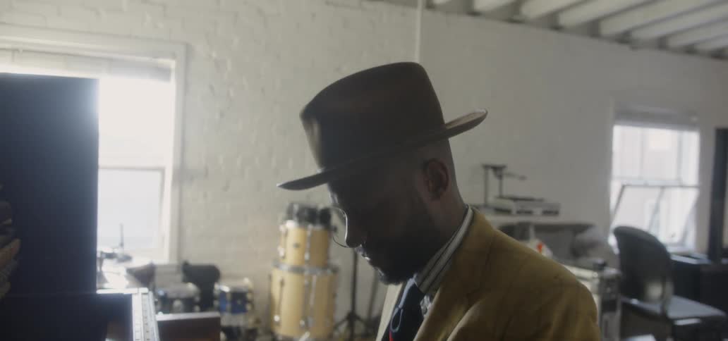 A man plays piano in a music room