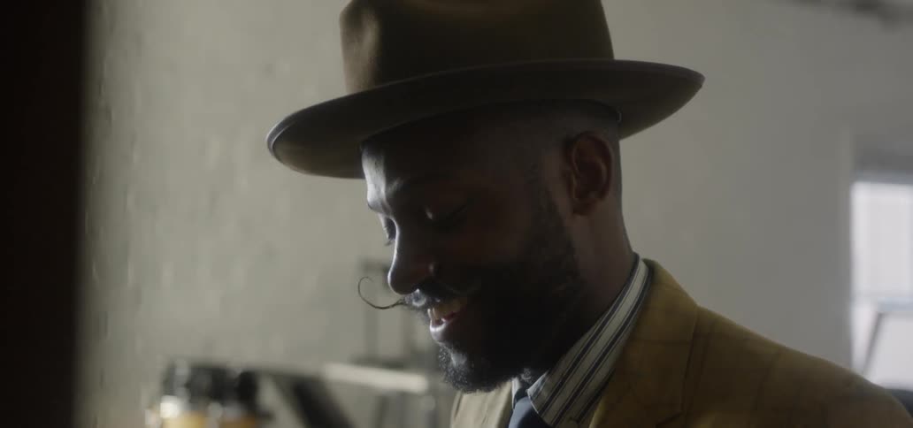 A man smiles while playing a piano