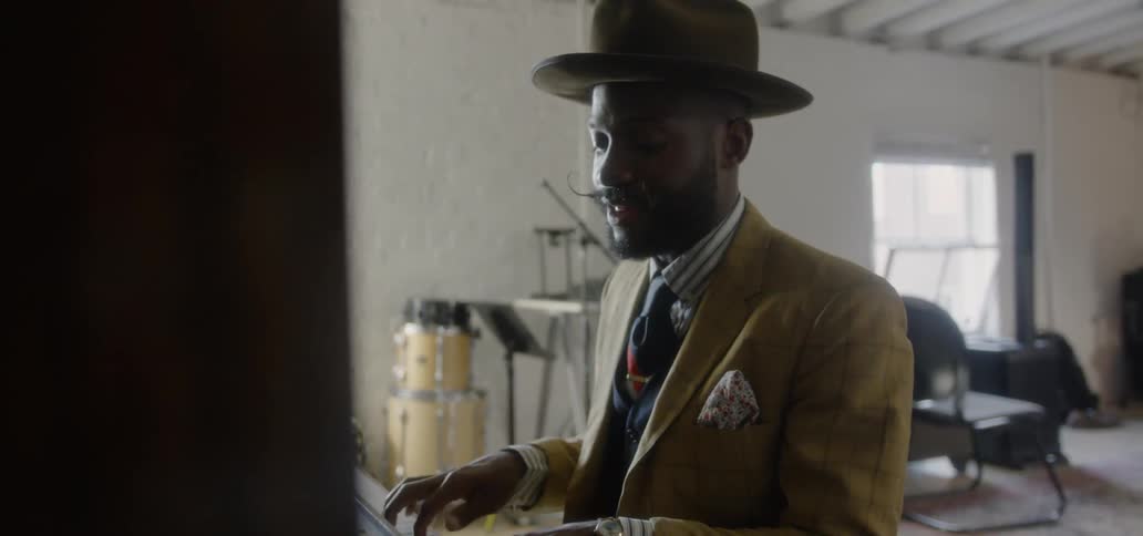 A man plays a piano in a music studio
