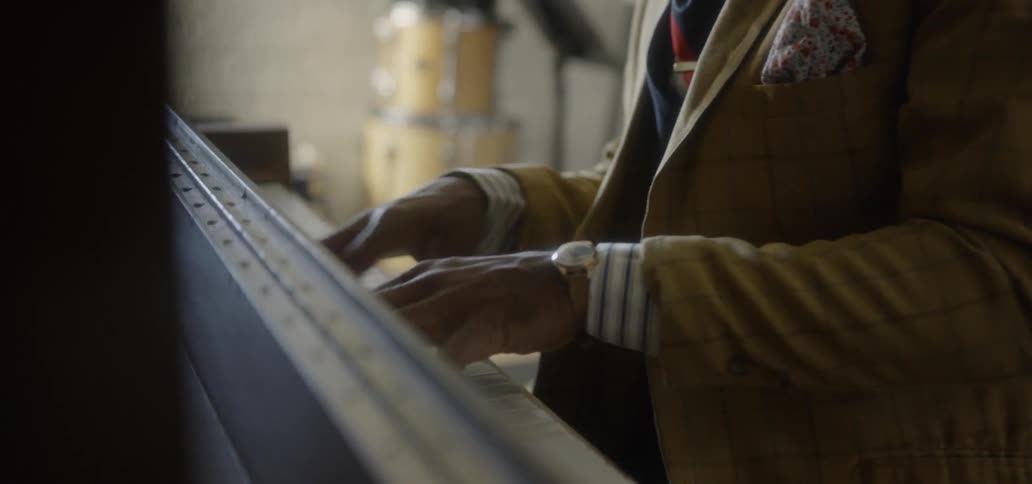 A man smiles while playing piano